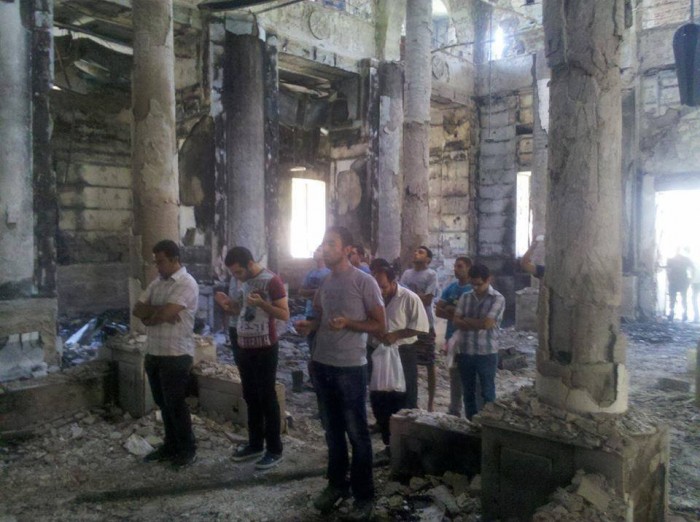 Copts pray in the burnt husk of a church
