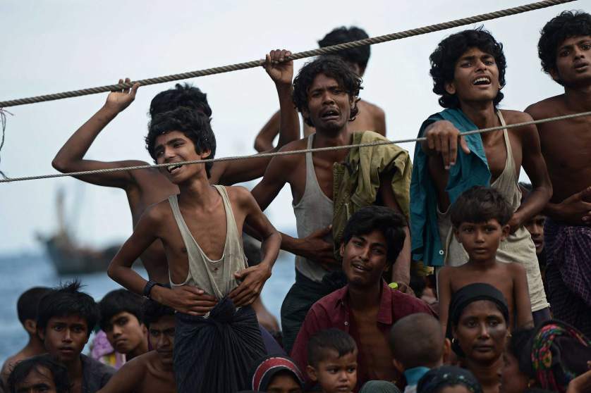 Rohingya migrants stand and sit on a boat drifting in Thai waters off the southern island of Koh Lipe in the Andaman sea on May 14, 2015.  The boat crammed with scores of Rohingya migrants -- including many young children -- was found drifting in Thai waters on May 14, according to an AFP reporter at the scene, with passengers saying several people had died over the last few days.     AFP PHOTO / Christophe ARCHAMBAULTCHRISTOPHE ARCHAMBAULT/AFP/Getty Images