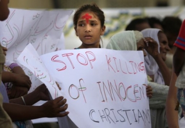 a-pakistani-christian-girl-stands-with-a-cross-on-her-forehead-while